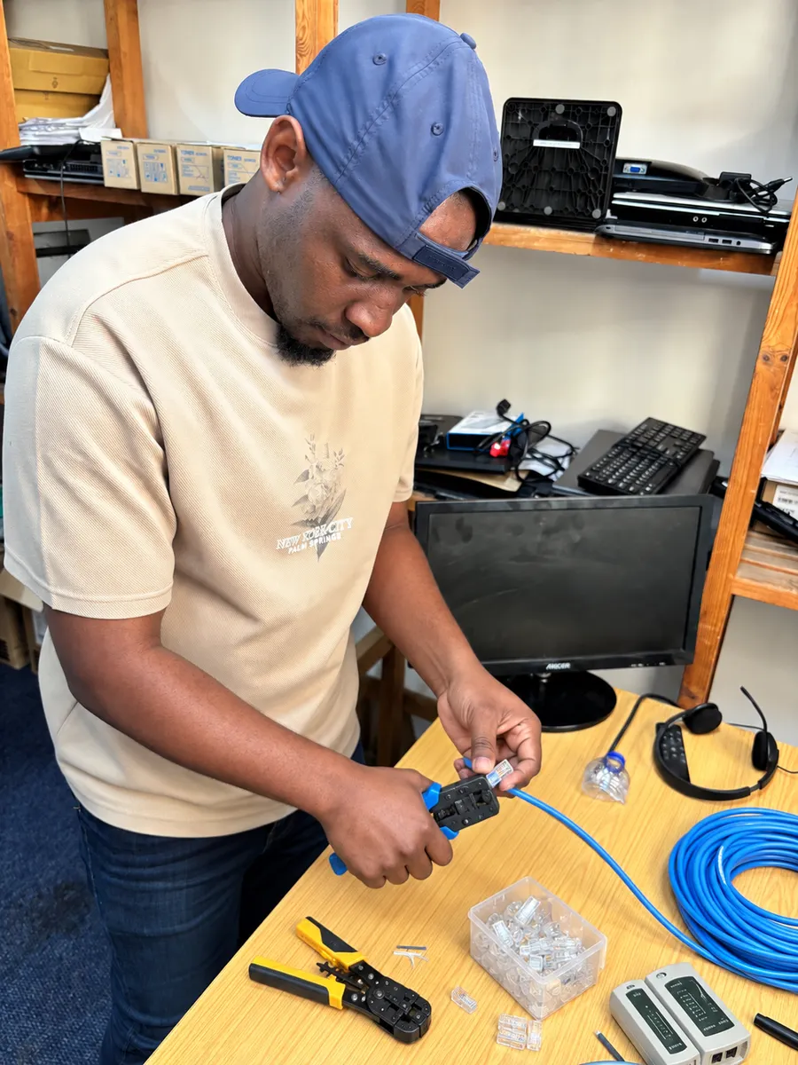 UXPERT crimping an Ethernet cable and preparing network connections