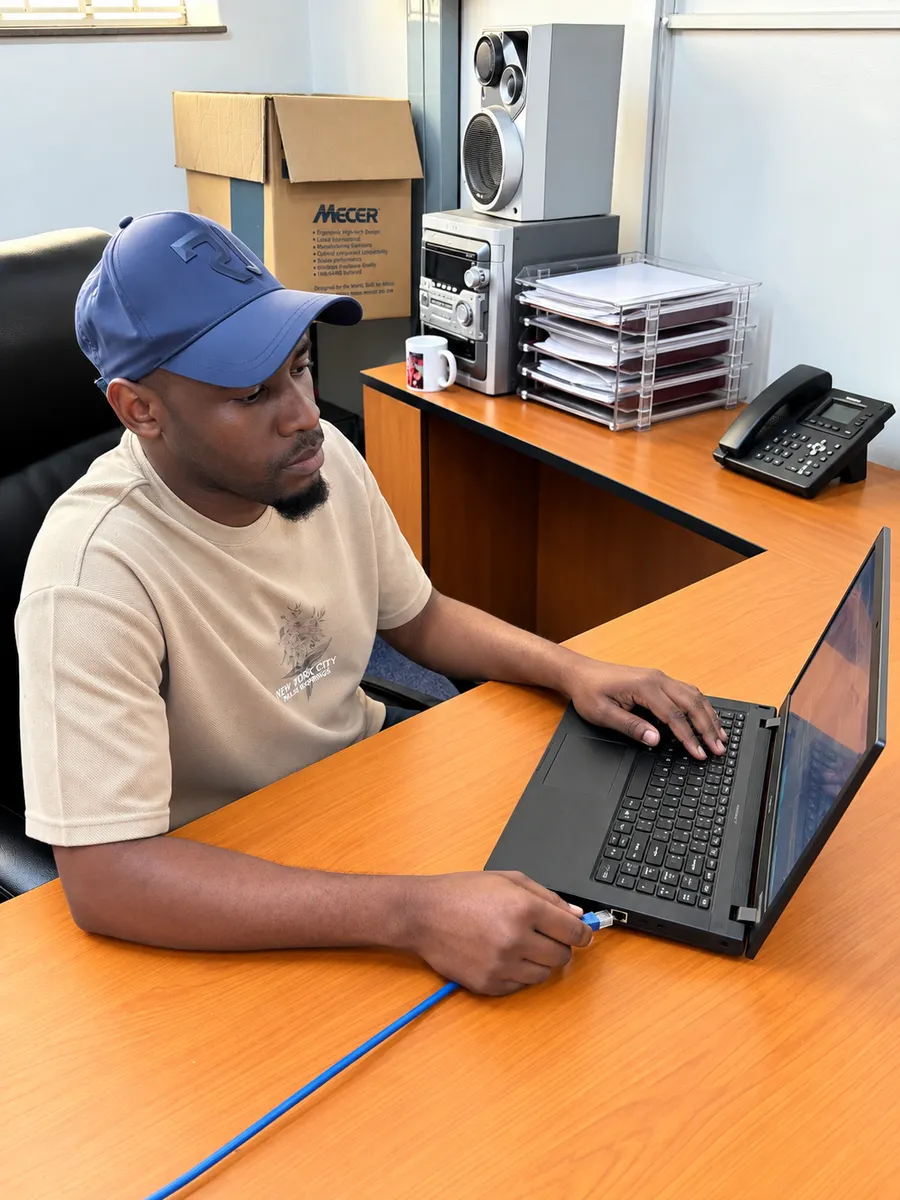 UXPERT connecting an Ethernet cable to configure a laptop network