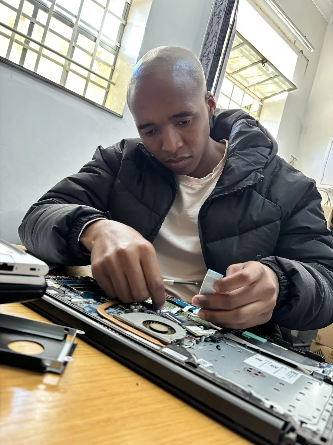 UXPERT technician repairing a laptop